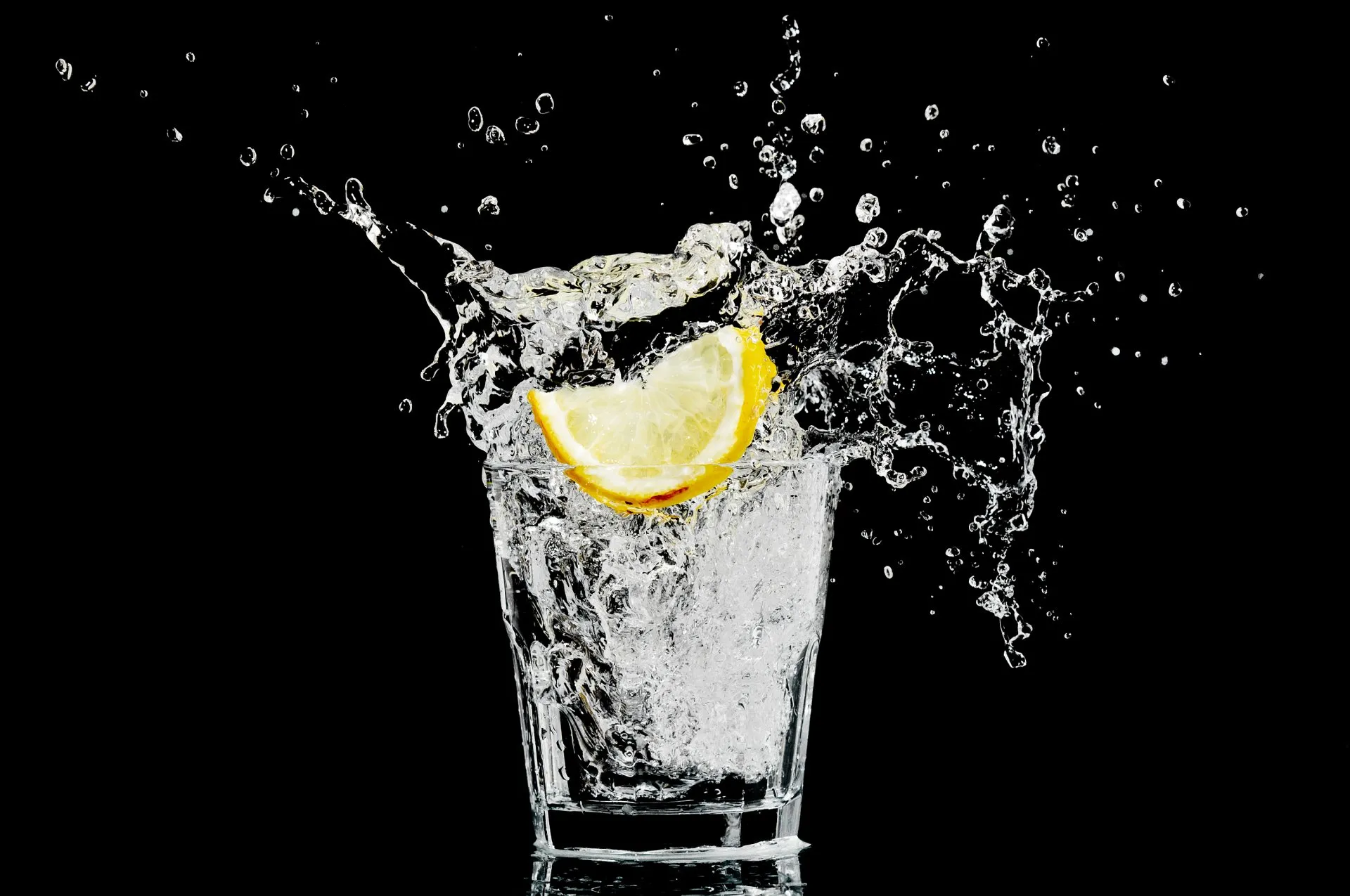 Lemon dropping into drink